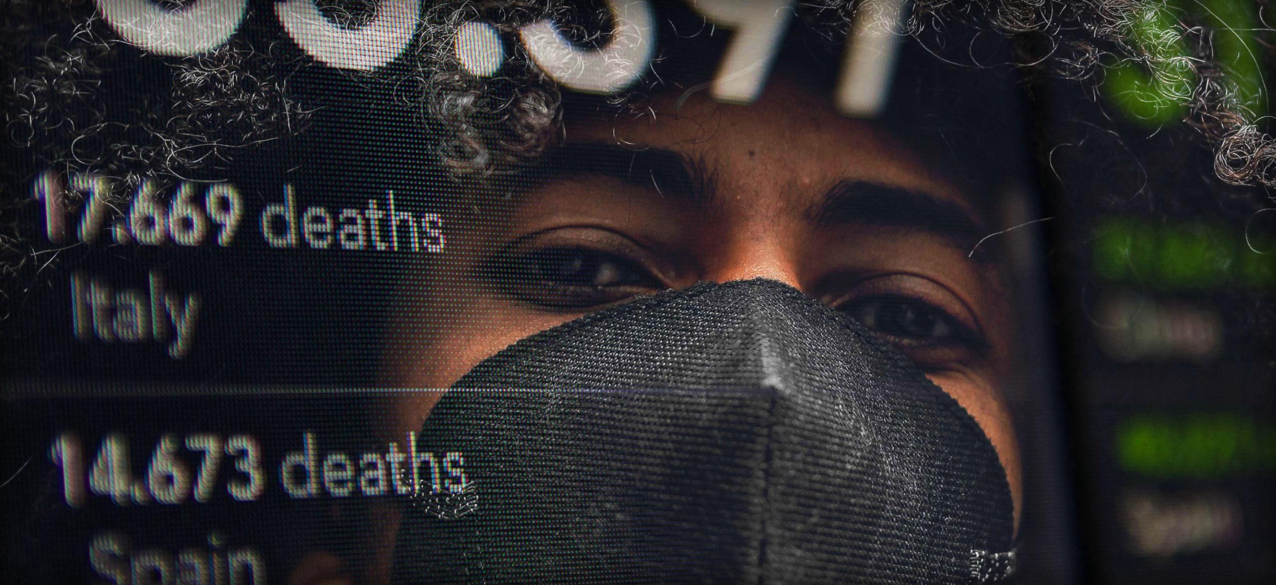 Photo illustration of a young adult wearing a mask. Young adults have been unfairly blamed for COVID-19 spread.