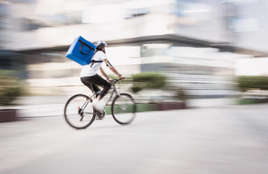 A gig economy worker on the bike riding in the city