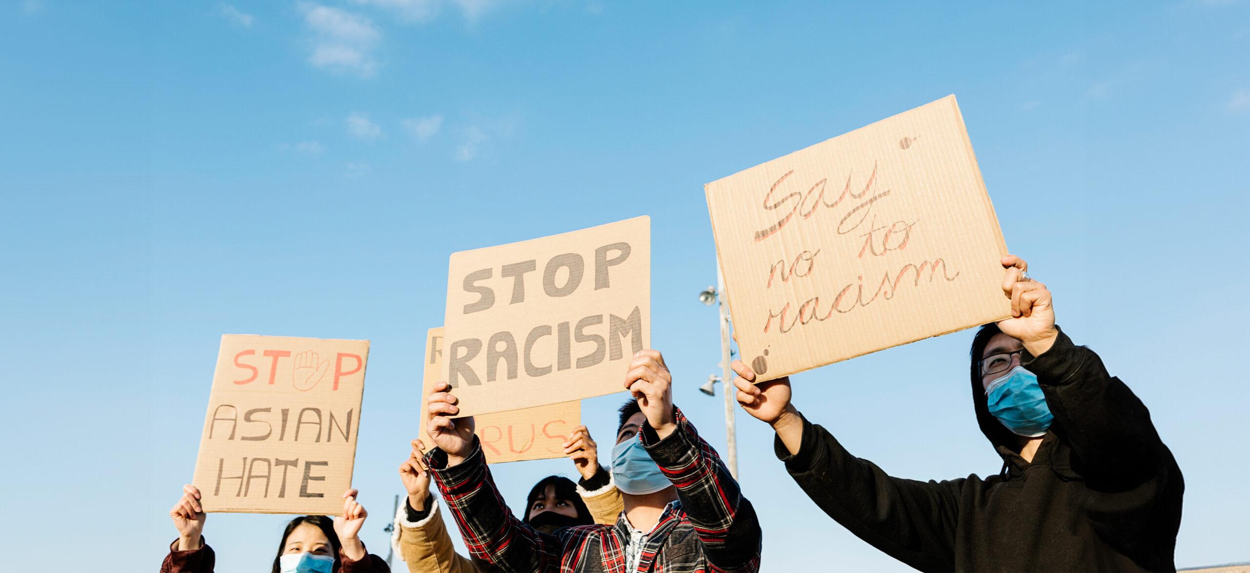 Asian people protest on the street against racism - Group of multiracial demonstrators from different asian countries fight for equal rights.